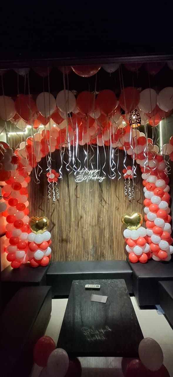 Red and white birthday balloon decoration setup