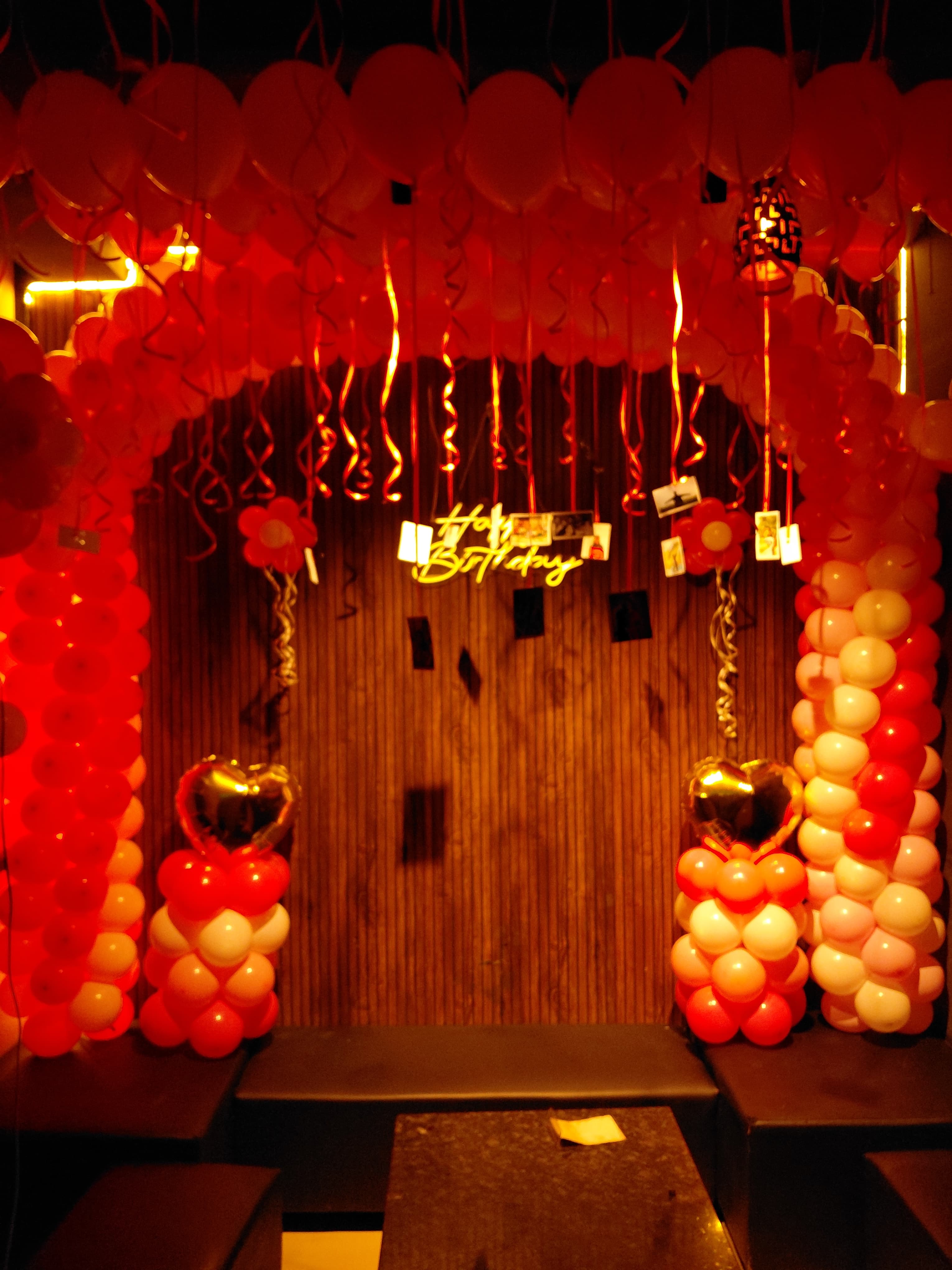 Warm red birthday balloon decoration at Black Door Cafe